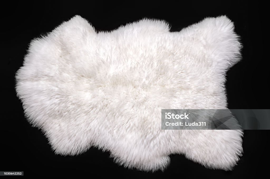 Beautiful white sheepskin isolated on a black background Rug Stock Photo