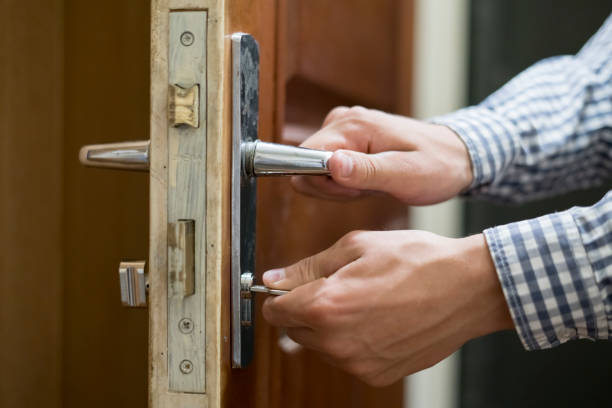 istock close up person hand in checkered shirt opens door  using keys 1030642308