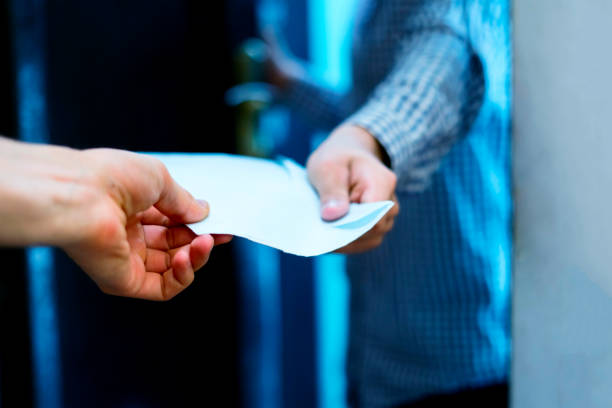 istock young postman brings letter envelope delivery to home 1030642332