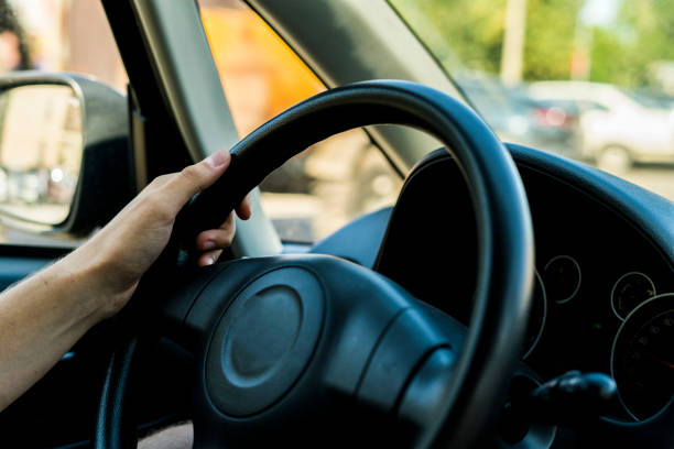 istock a close up man driving the car, cabin interior 1030643036