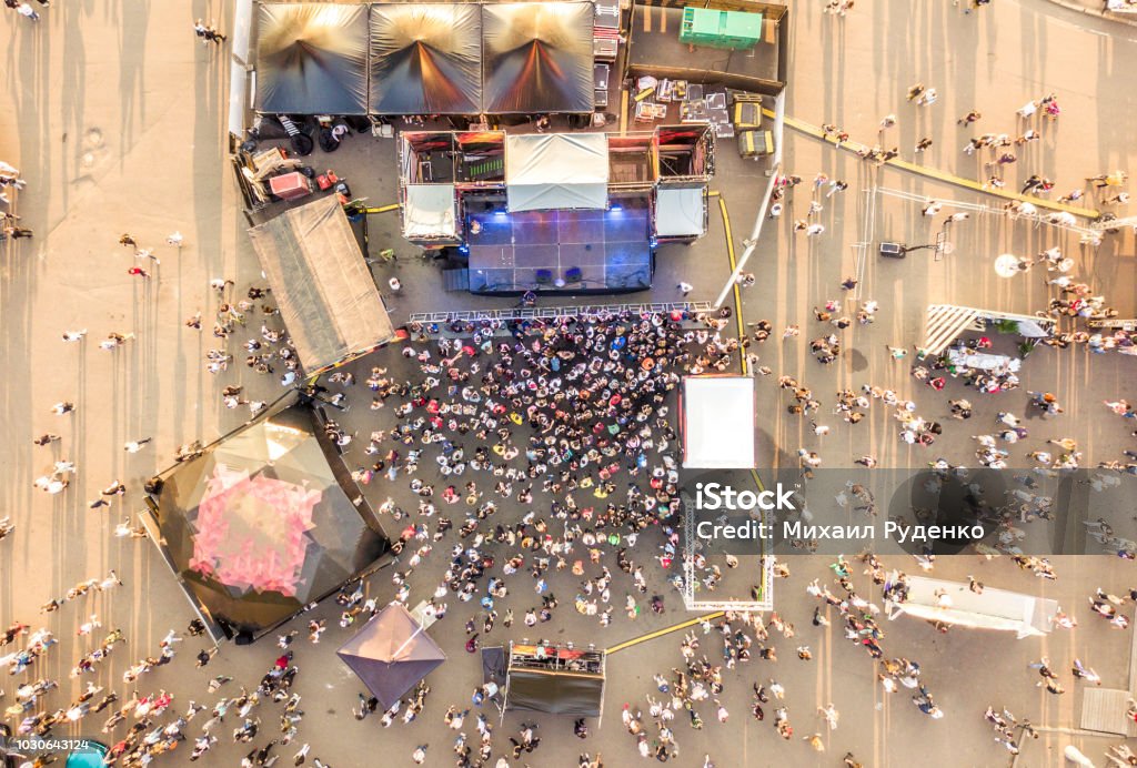 aerial top view of crowd of people standing near the stage on concert on summer day aerial top view of crowd of people standing near the stage on a concert on summer day Film Festival Stock Photo