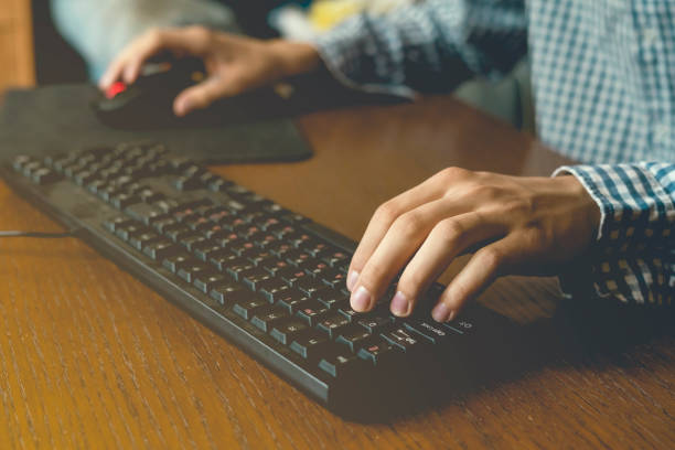 istock close up hands play video games on desktop pc at home on table using a keyboard and mouse 1030645464