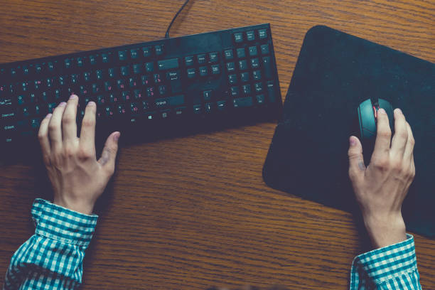 istock close up hands play video games on desktop pc at home on table using a keyboard and mouse 1030645470