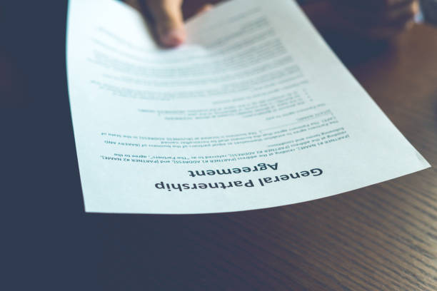istock partnership agreement business document signed by a person on the table in the  office 1030645578