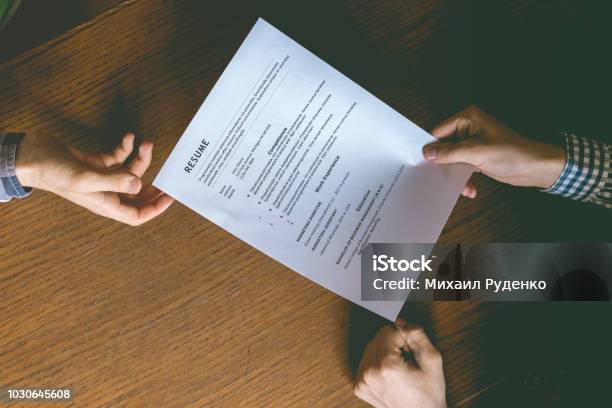 Top Overhead Directly Above View Of Employee Hiring Person And Examine The Resume On The Office Table Stock Photo - Download Image Now