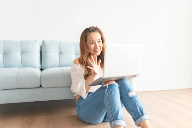 istock Pretty asian woman using computer at home 1030675266