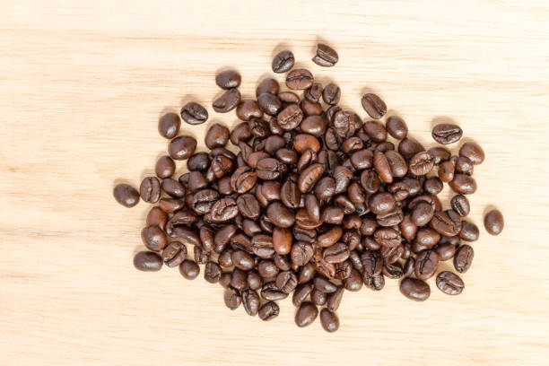 istock coffee beans on  wood texture  background. 1030678196