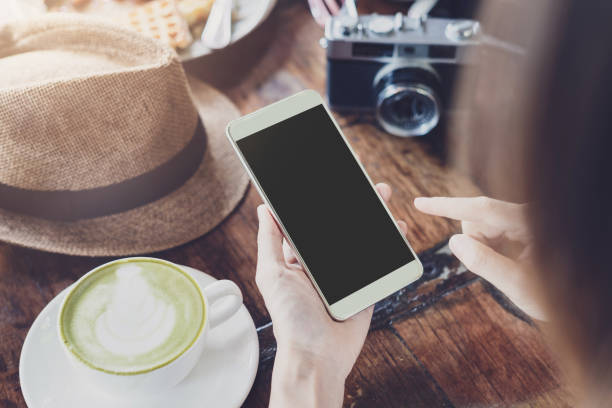 istock Young woman using smart phone and drinking coffee in cafe 1030686698