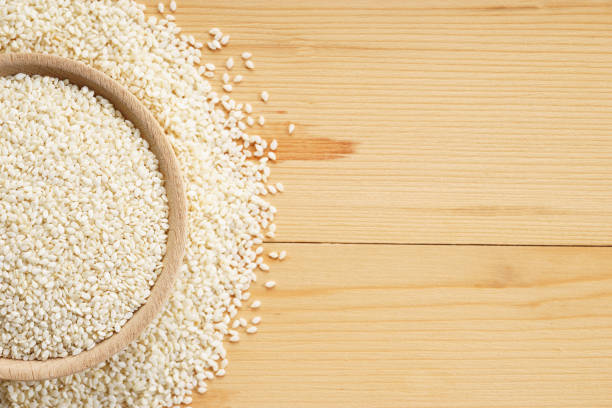 istock White sesame seeds on wooden background 1030686904
