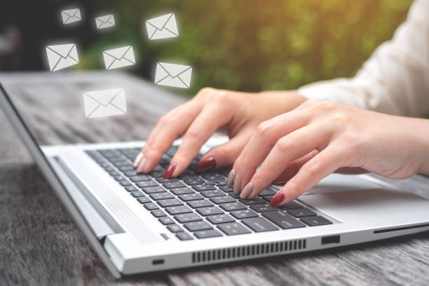 istock Business woman using Laptop pc to send e- mail with email icon, E-mail and communication concept. 1030702408