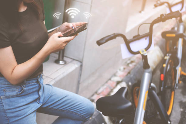 istock Female booking a public rental bicycle by application on smart phone. 1030702432