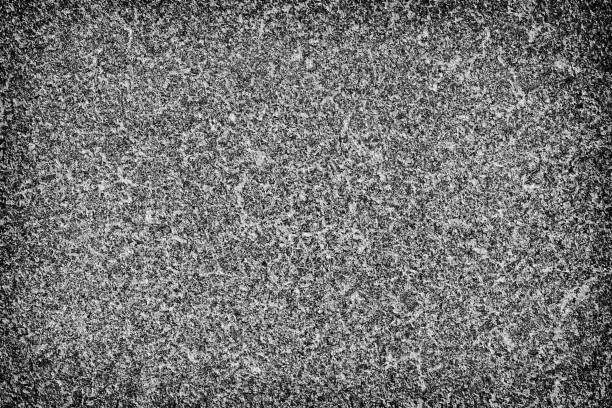 istock The texture is black and white in grunge style. Abstract monochrome background. Pattern of chips, cracks, scuffs, dust, stains 1030702684