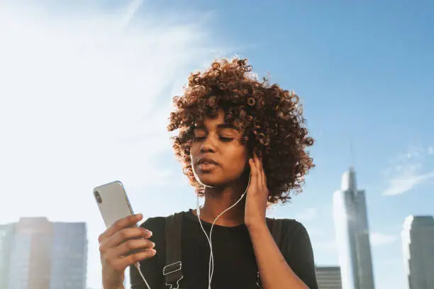 Photo of Girl listening to music from her phone