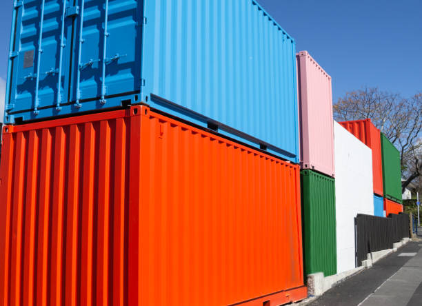 row of disused cargo containers paint in bright colors stacked row of disused cargo containers paint in bright colors stacked tauranga new zealand stock pictures, royalty-free photos & images