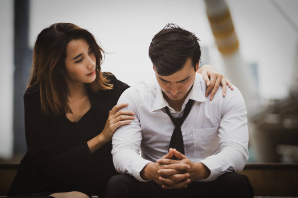 Couple with serious Tired depressed unemployed man stock photo