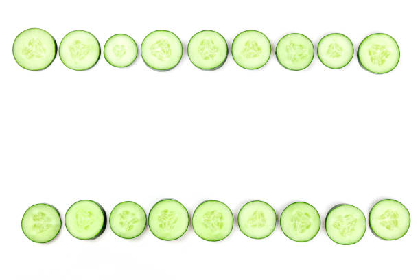 istock Cucumber slices forming a frame on a white background with copyspace 1030725292