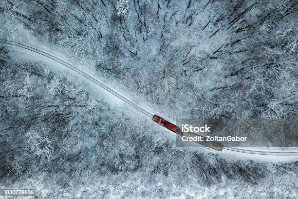 Budapest Hungary Aerial View Of Snowy Forest With Red Train On A Track At Winter Time Captured From Above Stock Photo - Download Image Now
