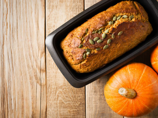 istock Homemade pumpkin cake with seeds on wooden background. 1030737310