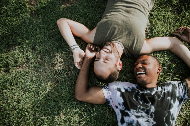 istock Gay couple relaxing in the grass 1030737332