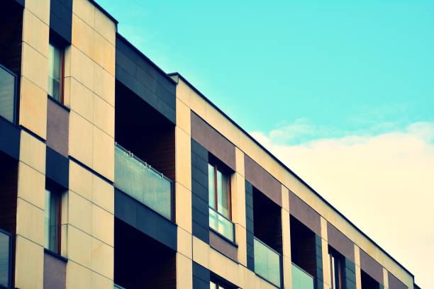 istock Modern apartment building exterior. Retro colors stylization 1030744472