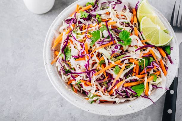 istock Cilantro lime coleslaw salad with red and white cabbage on stone background 1030747250