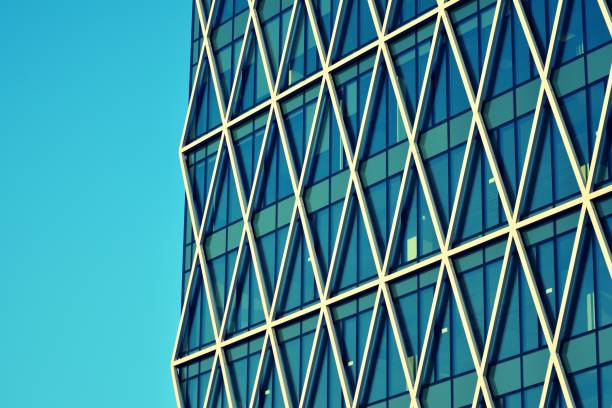 istock Modern office building on a clear sky background. Retro stylized colorful tonal filter effect 1030747504