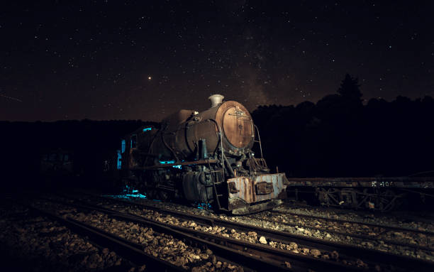 istock Old locomotive with blue light and Milky way 1030750650