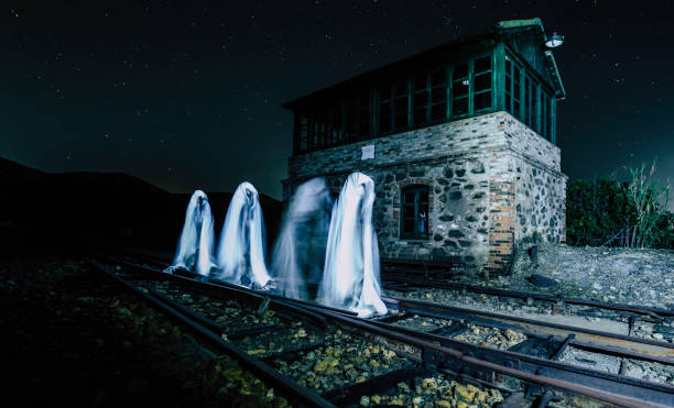 Four ghosts walking on the train track Four ghosts walking on the train track in front of the house haunted house stock pictures, royalty-free photos & images