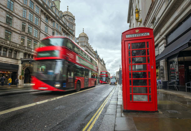 istock London, England - Iconic blurred red double-decker buses on the move with traditional red telephone box 1030750842