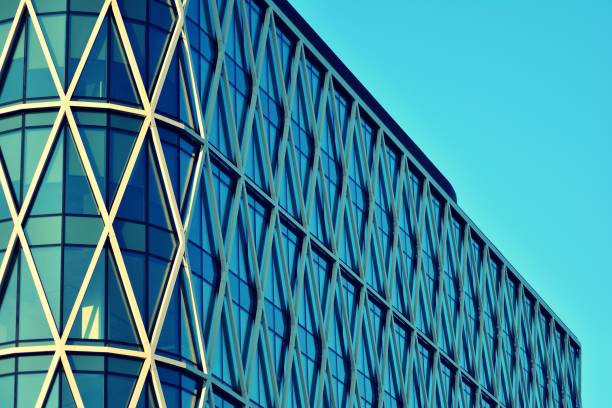 istock Modern office building on a clear sky background. Retro stylized colorful tonal filter effect 1030750994