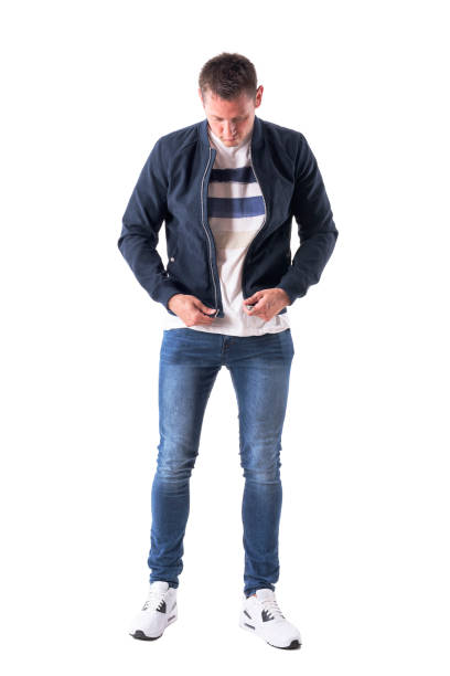 istock Young casual man getting dressed up holding and preparing to zip up jacket fastener 1030751176