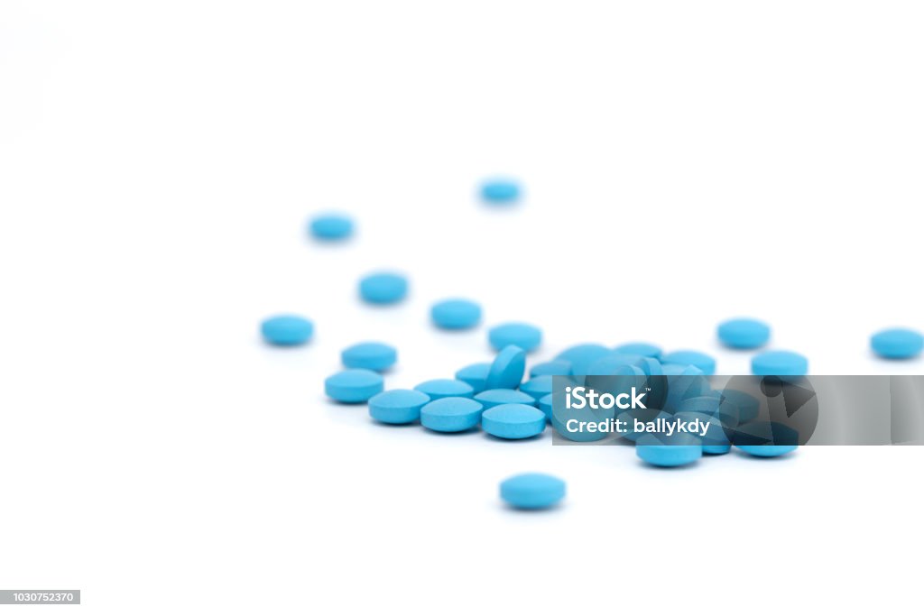 blue pills on white background blue pills on white background, selective focus Pill Stock Photo