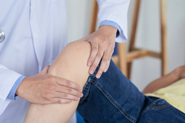 istock Anonymous doctor massaging knee of patient 1030755756