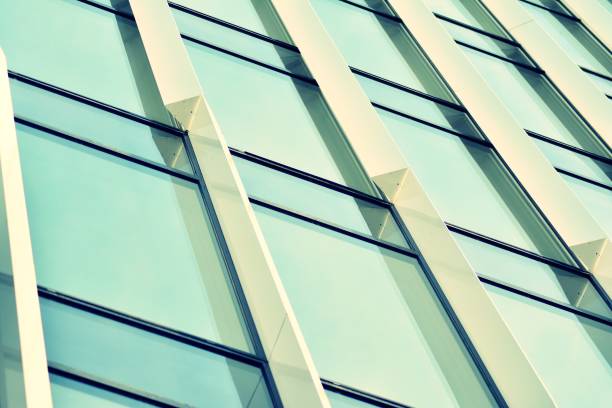 istock Modern office building on a clear sky background. Retro stylized colorful tonal filter effect 1030759314