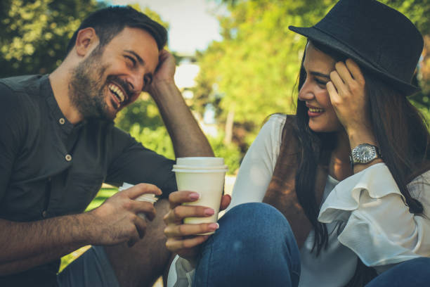 feliz pareja joven tomando café juntos. - couple outdoors coffee friendship fotografías e imágenes de stock