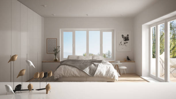 istock White table top or shelf with minimalistic bird ornament, birdie knick - knack over blurred contemporary bedroom with big windows, modern interior design 1030766976