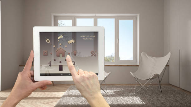 istock Smart remote home control system on a digital tablet. Device with app icons. Minimalist modern bright living room in the background, architecture interior design 1030770464