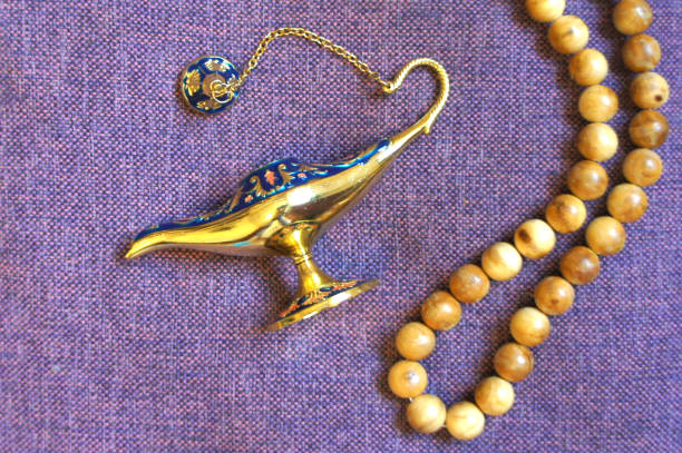 istock Small Antique magic Aladdin Lamp and rosary. Top view. 1030773758
