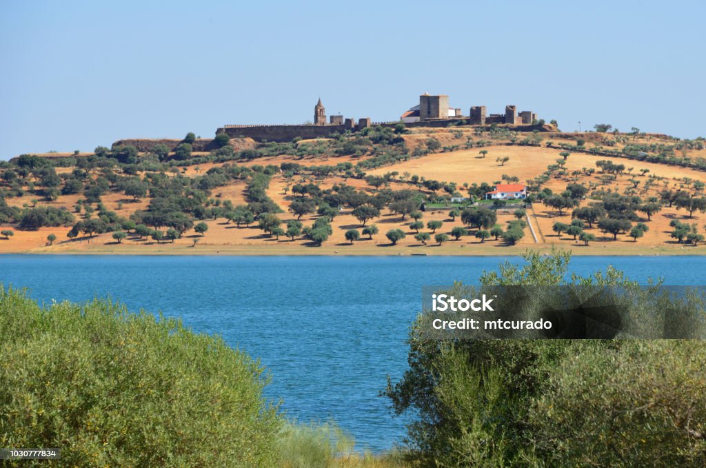 Mourão medieval town and the Alqueva dam reservoir, Alentejo, Portugal Mourão, Évora district, Portugal: the walled town on its hill top, above the vast lake of the Alqueva reservoir Alentejo Stock Photo