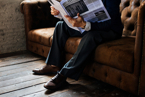 Senior businessman reading newspaper at cafe