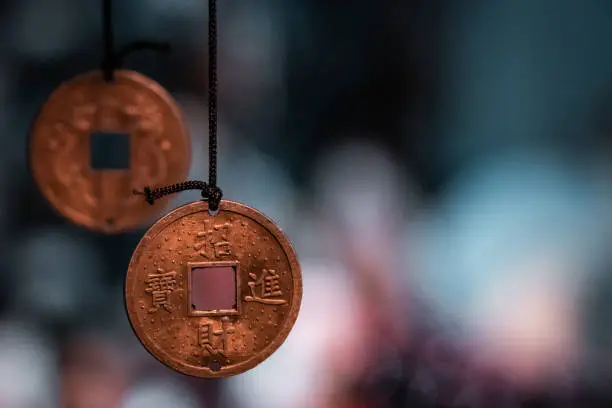 Chinatown market in Hong Kong, gadgets and typical traditional objects such as pending holed coins, isolated on a blue background.