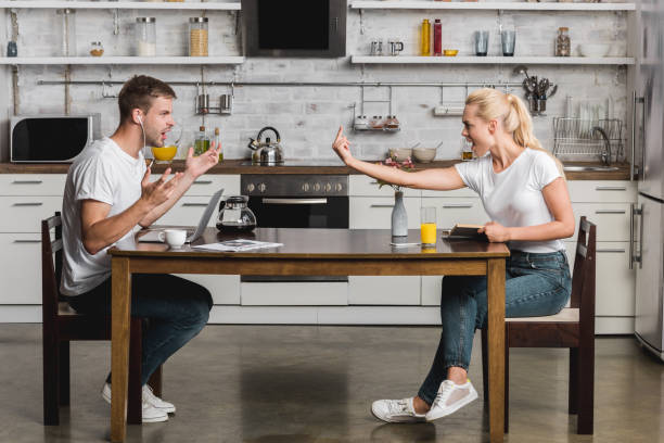istock side view of young couple quarreling during breakfast in kitchen 1030783970