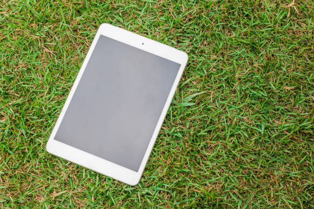 istock tablet 8.4 inches on green glass 1030784368