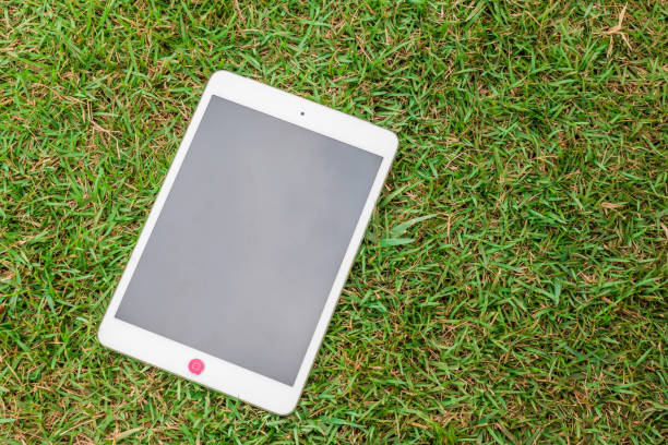istock tablet 8.4 inches on green glass 1030787442