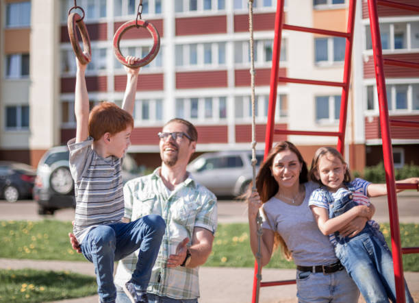 istock young family on the Playground 1030791596