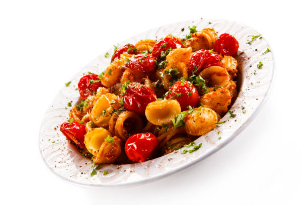 istock Pasta with meat and vegetables on white background 1030792008