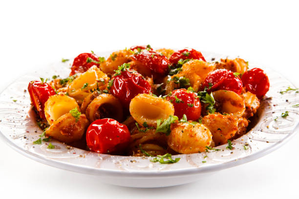istock Pasta with meat and vegetables on white background 1030792102
