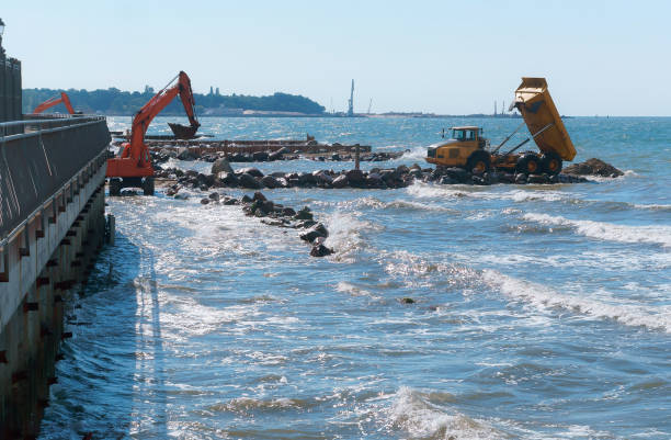 istock coastal protection measures, construction equipment on the shore, the construction of breakwaters 1030792212