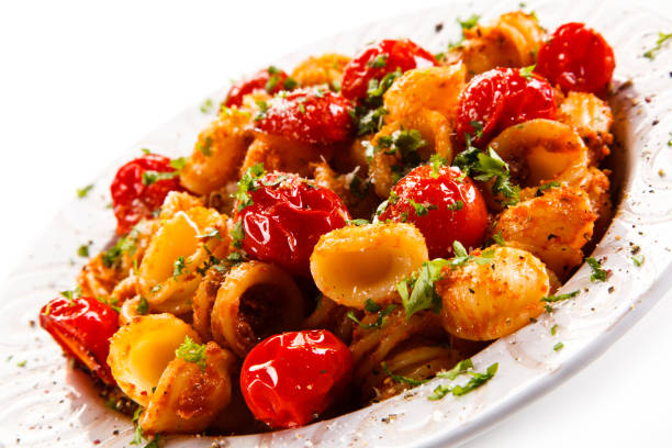 istock Pasta with meat and vegetables on white background 1030792244