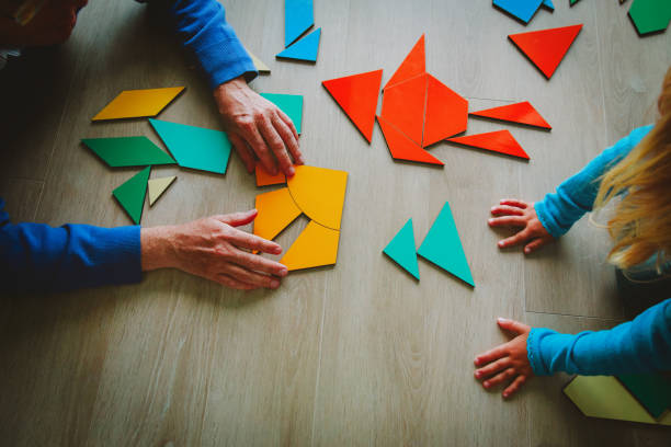 istock teacher and child playing with geometric shapes 1030795956